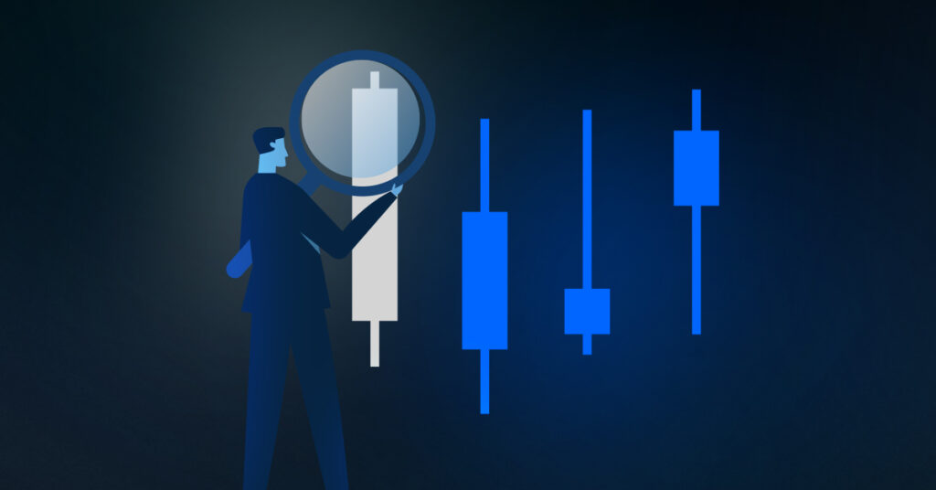 An image of candlestick chart being examined by a trader for an article about candlestick patterns. 